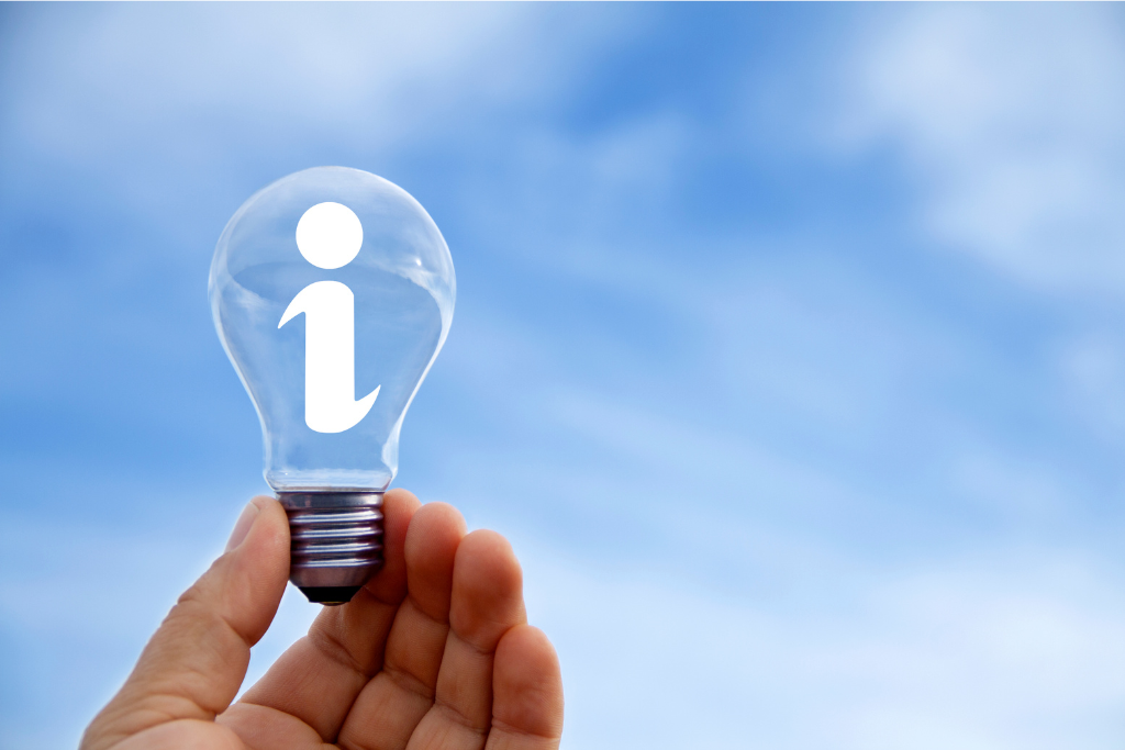 hand holding a lightbulb with the letter I on it and a blue sky in the background